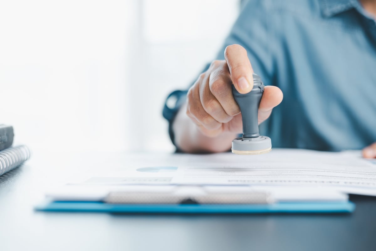 Process server stamping an approved legal document