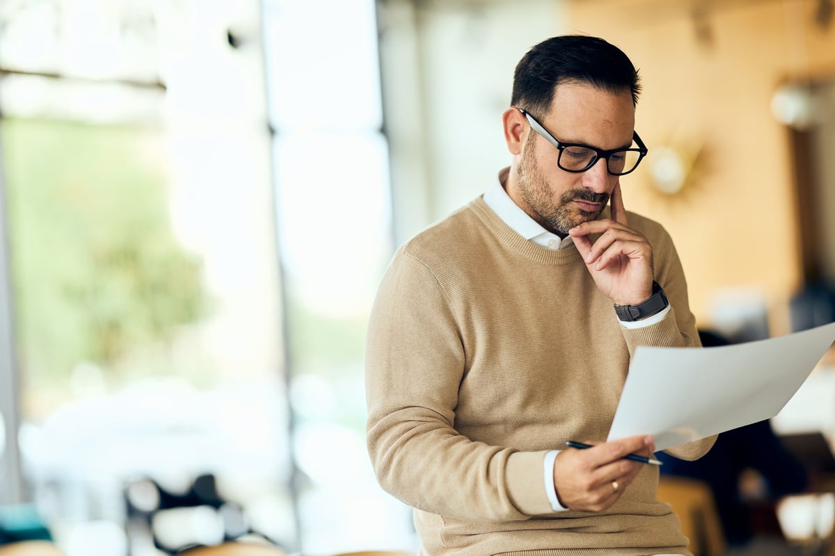 Legal professional reading a document in a bright office